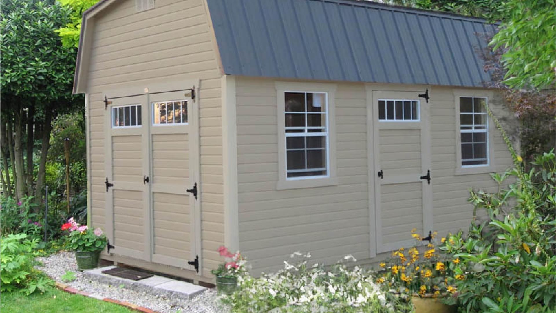 Light tan Signature High Barn with light tan trim, double doors, windows, and a gray roof.